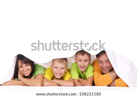 portrait of a family lying under the cover
