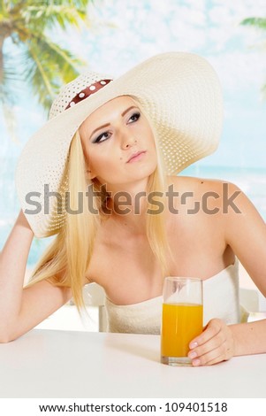 Charming blonde with a bright appearance is resting at a resort