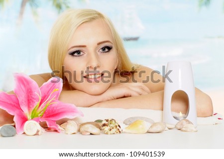 Attractive blonde with a bright appearance is resting at a resort