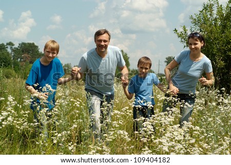 Happy family having fun in the company of each other on the nature