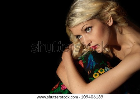 Beauteous blonde with a bright appearance on a black background
