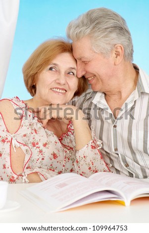 Beautiful older couple resting in the bedroom after a hard working week