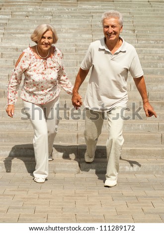 Nice elderly couple went for a walk around the city