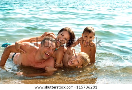 Cheerful family came to the beach to relax sea
