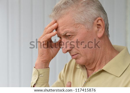 cute older man poses in a room