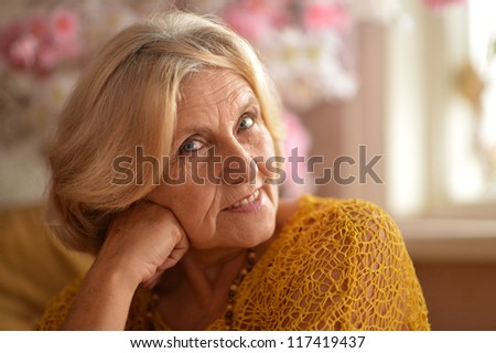 happy older woman poses in a room