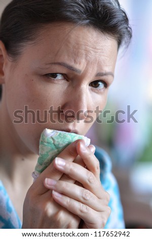a cold young woman with handkerchief coughs