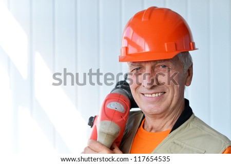 portrait of a smiling jack of all trades with a tool