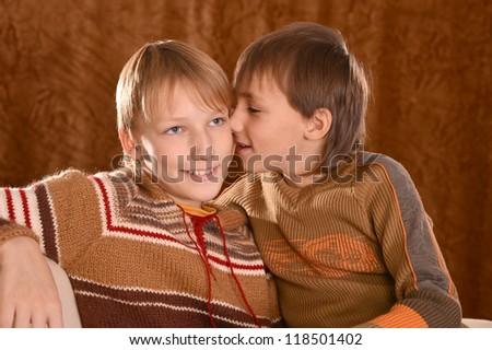 portrait of a beautiful happy brothers posing on a brown