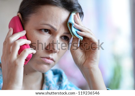 young woman with a handkerchief and a cold call the doctor