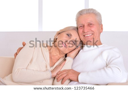 Happy beautiful elderly couple relaxing at home