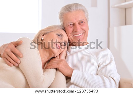 Happy beautiful elderly couple relaxing at home