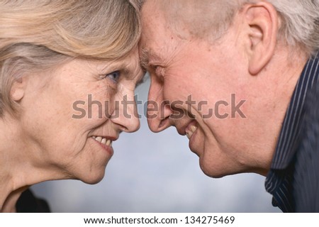 portrait of a happy senior couple over a gray background