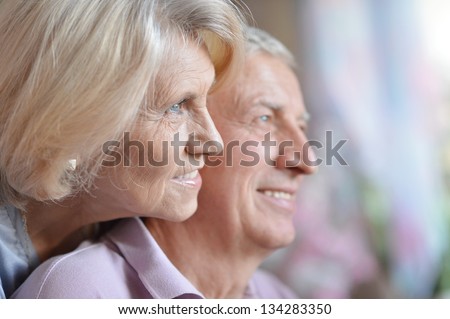 close-up portrait of a happy senior couple at home