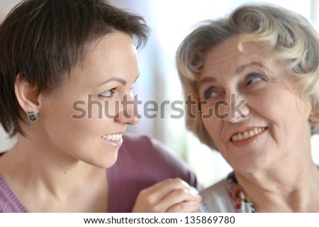 close-up portrait of a happy older woman and a young woman