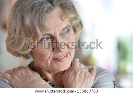 close-up portrait of a happy older woman in studio