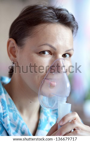 close-up portrait of a young woman doing inhalation