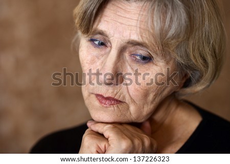 close-up portrait of an older woman over beige background
