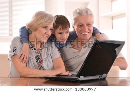 portrait of a boy with his grandparents at home