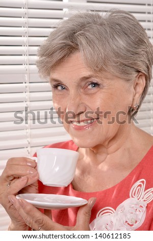 portrait an older woman drinking coffee in the morning