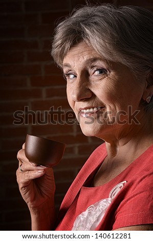 portrait an older woman drinking coffee in the morning