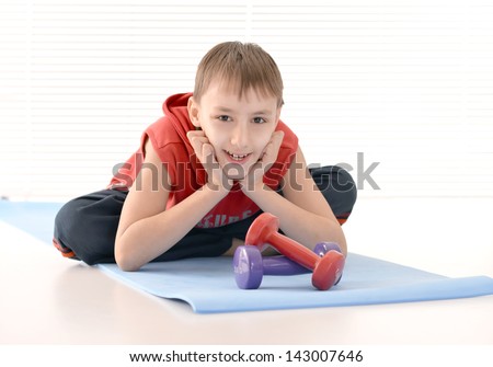 athletic guy in the red shirt on a light background