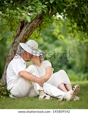 happy Mature couple walks in the park in summer day
