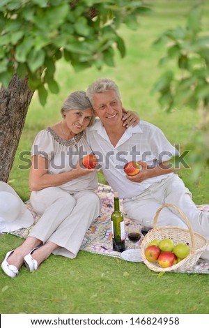 loving aged couple spends time together in the summer outdoors