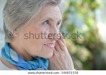 Portrait of an aged woman with a blue neck scarf home