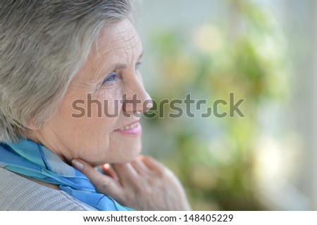 Portrait of an older woman with a blue neck scarf home