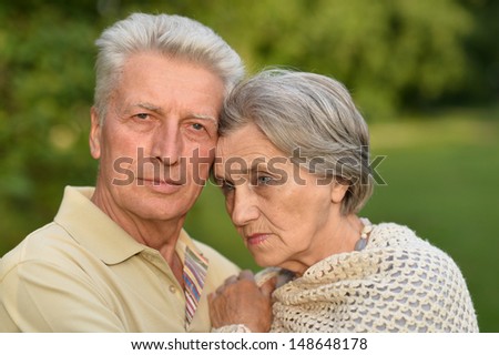 elderly man and an elderly woman embracing