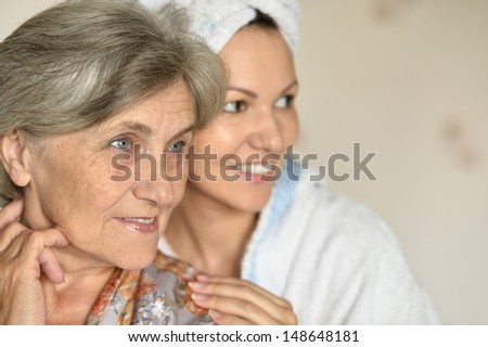 happy young woman with her elder mother at home