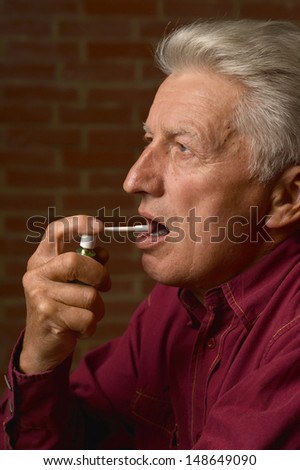 old man in a shirt on a brick background
