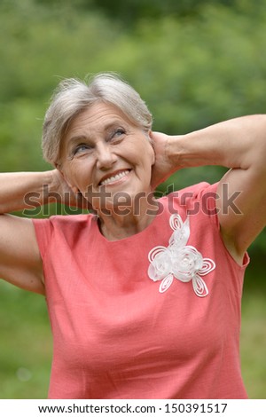 Old beautiful woman posing outdoors