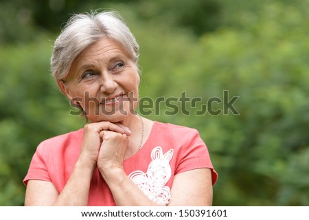 Old beautiful woman posing outdoors