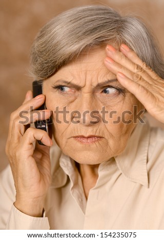 elder sad woman with phone