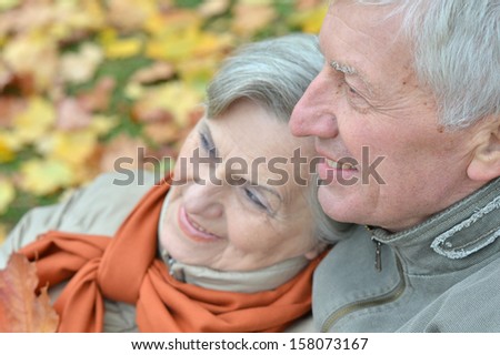 attractive older couple on a walk in the park fall