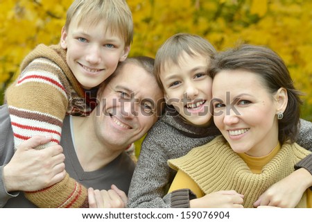 happy family on a walk in the park early fall