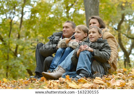 nice happy family for a walk in the park in autumn