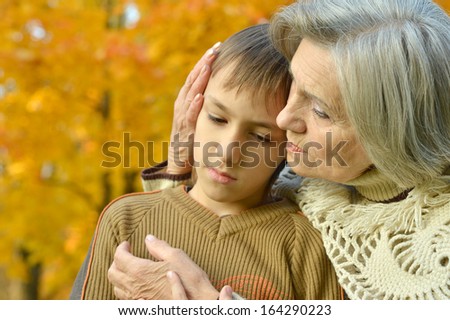 beautiful grandmother with her grandson on a walk