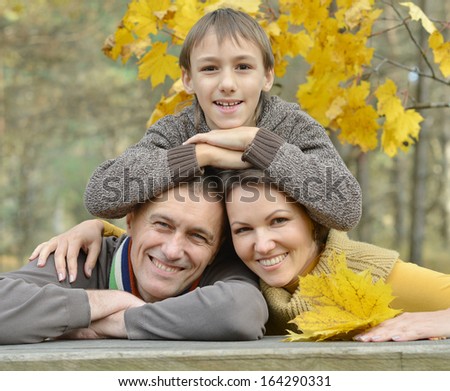 Portrait of a happy family of three on the nature at table