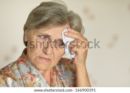 old woman with a handkerchief at home