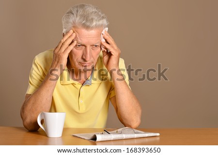 Portrait of older man sitting at table