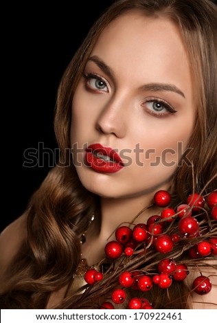 Beautiful young girl berries on a black background