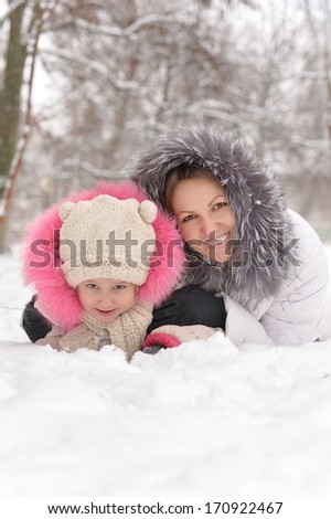 Mother and daughter having fun in the snow.