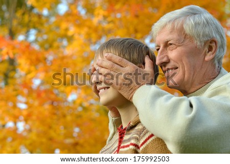 Portrait of a grandfather with grandchild at park