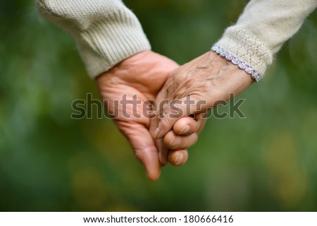 Similar – Image, Stock Photo Pair of old hands scrolling over a white screen with copy space phone in a living room