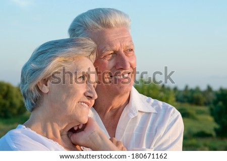 Old couple in love walking in the park in spring