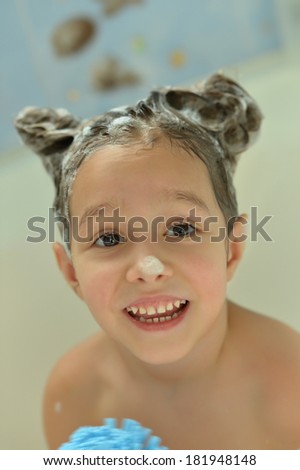 Funny little girl in bath at home