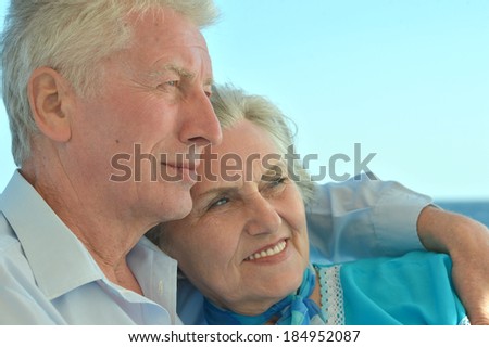 Happy senior couple on a sky background